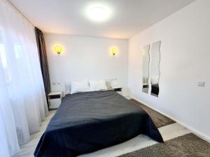 Un pat sau paturi într-o cameră la Vila Giulia Voineasa