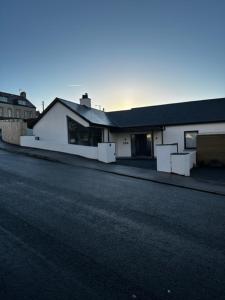 a white building on the side of a street at Seabreeze Cottage in Portstewart