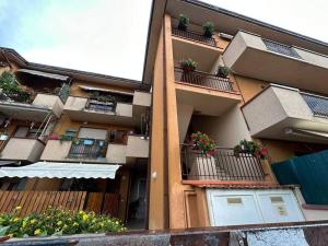 un immeuble d'appartements avec des plantes en pot sur les balcons dans l'établissement Tra il Mare e il centro di Viareggio - Casa Lilla, à Viareggio