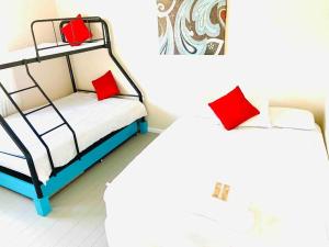 a room with two bunk beds with red pillows at House At the Heart of Shellharbour in Shellharbour