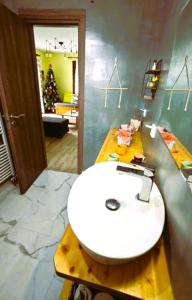 a bathroom with a white sink on a counter at River House in Volos