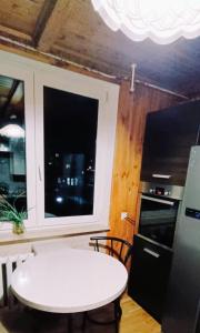 een keuken met een witte tafel en een raam bij Apartament NG in Wieliszew