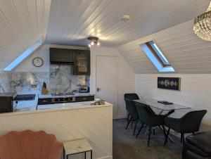 a room with a kitchen and a table with chairs at Morrigan 7-Hot Tub-Pet Friendly-Boutique-Perthshire-Families in Perth