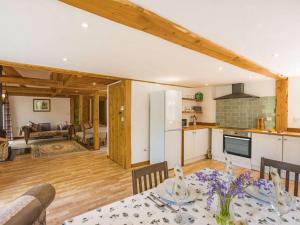 a kitchen and a living room with a table and a kitchen at 3 Bed in Chulmleigh 87779 in Eggesford