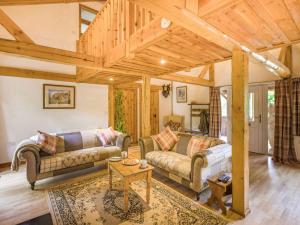 a living room with two couches and a table at 3 Bed in Chulmleigh 87779 in Eggesford