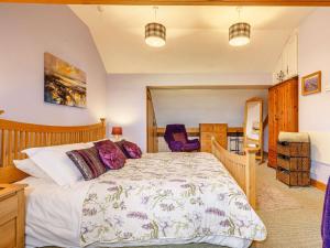 a bedroom with a large bed with a wooden headboard at 2 Bed in Kielder 88214 in Yarrow