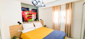 sypialnia z łóżkiem i obrazem na ścianie w obiekcie Apartamento “La Guapa” Benidorm! w mieście Benidorm