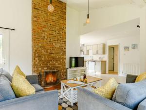 a living room with two blue couches and a fireplace at 2 Bed in Whitsand Bay 88311 in Landrake