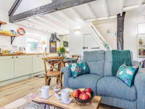 a living room with a blue couch and a table at 1 Bed in Lanhydrock 88165 in Bodmin