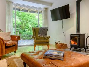 a living room with a couch and a fireplace at 2 Bed in Cunsey 88319 in Far Sawrey