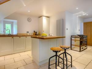 a kitchen with a counter and two stools in it at 2 Bed in Cunsey 88319 in Far Sawrey