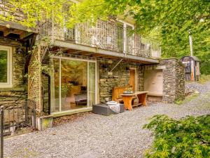 a stone house with a balcony and a patio at 2 Bed in Cunsey 88319 in Far Sawrey