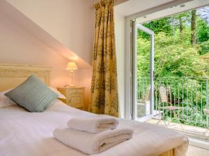 a bedroom with a bed and a large window at 2 Bed in Cunsey 88319 in Far Sawrey