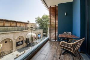 a balcony with a table and chairs on a building at Island City Boutique Hotel in Rhodes Town