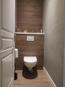 a small bathroom with a toilet and a sink at La Frênaie in Saint-Cyr-sur-le-Rhône