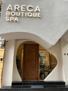 a building with a sign that reads acne boutique spa at Areca Boutique Apartments Hanoi in Hanoi