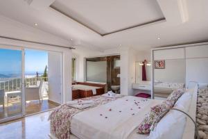 a bedroom with a large bed and a balcony at Villa Mono / Kalkan in Kas