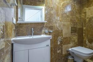 a bathroom with a sink and a toilet at Villa Mono / Kalkan in Kas +10 photos