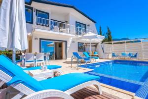 a villa with a swimming pool and patio furniture at Villa Mono / Kalkan in Kas