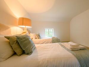 a bedroom with two beds and a window at 3 Bed in Buttermere 88773 in Buttermere