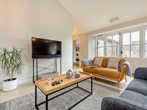 a living room with a couch and a table at 2 Bed in Ventnor 88857 in Niton