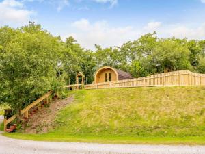 a house on top of a hill with a fence at 1 Bed in Ennerdale Bridge 88672 in Frizington