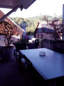 a table with a bowl on it on a patio at "Côté nature", appartement cosy au cœur de Munster in Munster