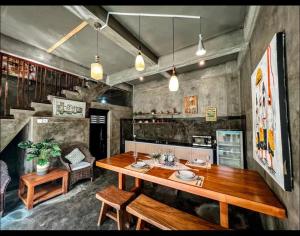 a dining room with a wooden table and benches at BIU BALI in Sempidi