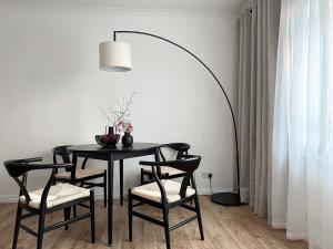 a dining room with a black table and chairs at 2-BR Flat with Style and Comfort in St John’s Wood in London