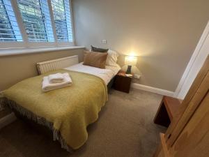 a bedroom with a bed with a towel on it at 3 Bed in Hawkshead 88985 in Near Sawrey