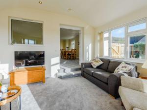 a living room with a couch and a fireplace at 4 Bed in Braunton 89603 in Braunton