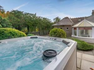 a hot tub in the backyard of a house at 6 Bed in St Andrews 89572 in Leuchars