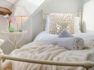 a bedroom with a white bed with a towel on it at 4 Bed in Bath 89616 in Mells