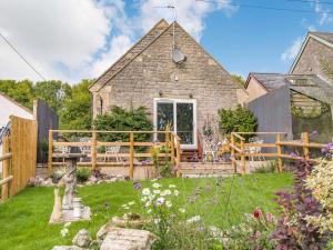 a stone house with a garden in front of it at 4 Bed in Bath 89616 in Mells