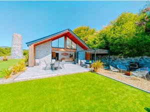 a home with a large yard with a lawn at CORNWALL LUXURIOUS UNIQUE New Build PALMA VILLA# 4miles EDEN PROJECT, BEACH & HARBOUR # Private Location, Encllosed Garden with View, Underfloor Heating, Coffee Machine# Walking-Cycling Path, Pet Friendly in St Austell