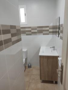 a bathroom with a sink and a toilet at Camping Barraquetes in Sueca