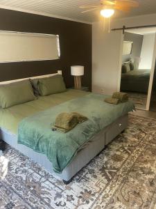 a large bed in a bedroom with a mirror at Florie se Huis in Paarl