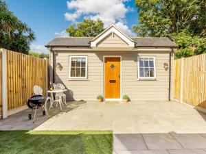 a small shed with a orange door in a yard at 1 Bed in Broadstairs 89391 in Broadstairs