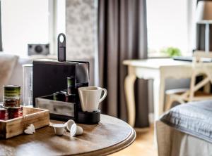 a coffee maker on a table in a living room at Freys Hotel in Stockholm