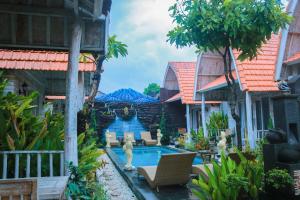 a swimming pool in the middle of a house at The Box Paradise Cottage in Nusa Penida