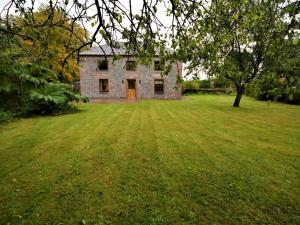 an old brick house in a field with a tree at 3 Bed in Lockerbie 89759 in Ecclefechan