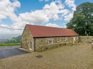 a small stone building with a red roof at 4 Bed in Durham 89858 in Willington