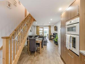 a kitchen and living room with a table and a staircase at 1 Bed in Polyphant 89860 in Trewen