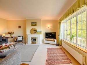 a living room with a couch and a fireplace at 4 Bed in Bridport 89788 in Corscombe