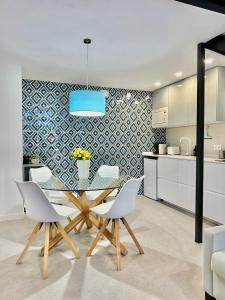 a kitchen and dining room with a glass table and chairs at Loft Valencia Benimaclet in Valencia