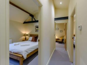 a bedroom with a bed and a room with a hallway at 3 Bed in Leyburn 89746 in Spennithorne