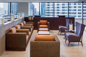 a waiting area with chairs and tables in a building at Hyatt House New Orleans Downtown in New Orleans