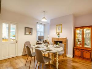 a dining room with a table and chairs at 3 Bed in Llanfairfechan 89646 in Llanfairfechan
