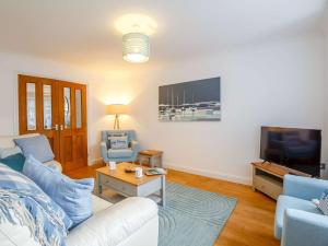 a living room with a couch and a tv at 4 Bed in Llandudno 89703 in Deganwy