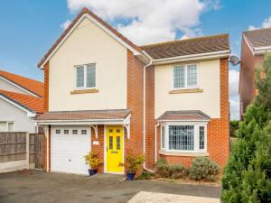 a brick house with a yellow door at 4 Bed in Llandudno 89703 in Deganwy